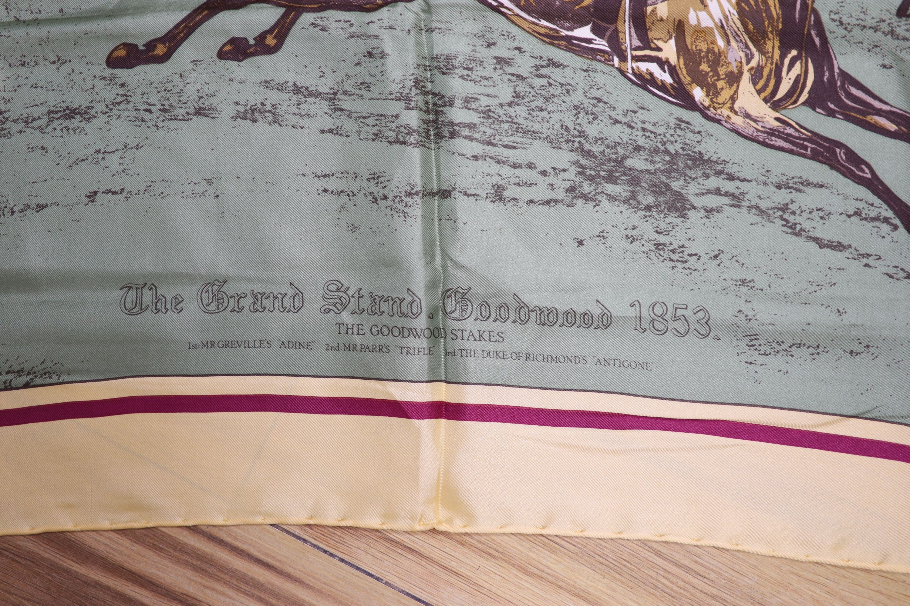 A Liberty silk scarf with a printed horse racing scene, with slip case